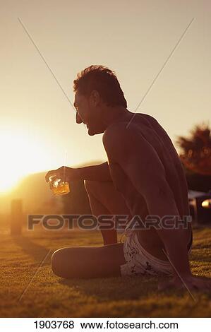 a man sits on the beach with a drink; tarifa, cadiz, andalusia, spain View Large Photo Image Stock Photo - a man sits on the beach with a drink; tarifa, cadiz, andalusia, spain. Fotosearch