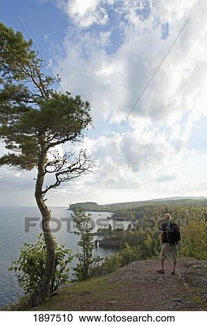 a man standing on the north shores of lake superior in tettegouche state park; minnesota, united states of america View Large Photo Image Stock Image - a man standing on the north shores of lake superior in tettegouche state park; minnesota, united states of america. Fotosearch