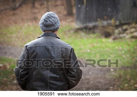 a man wearing a hat standing in a snowfall; grimsby, ontario, canada View Large Photo Image Stock Image - a man wearing a hat standing in a snowfall; grimsby, ontario, canada. Fotosearch