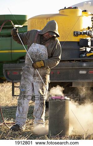 a person cleans a filter for farm equipment; three hills, alberta, canada View Large Photo Image Stock Image - a person cleans a filter for farm equipment; three hills, alberta, canada. Fotosearch