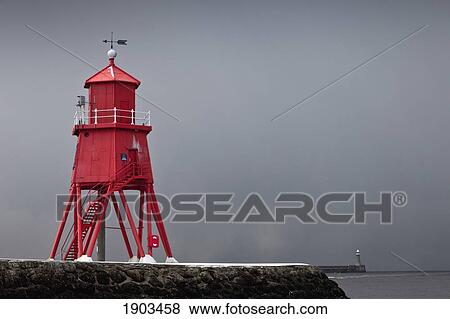 a red lighthouse under a stormy sky along the coast; south shields, tyne and wear, england View Large Photo Image Stock Photo - a red lighthouse under a stormy sky along the coast; south shields, tyne and wear, england. Fotosearch