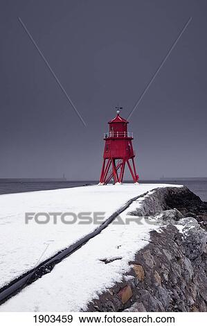a red lighthouse under a stormy sky along the coast in winter; south shields, tyne and wear, england View Large Photo Image Stock Photo - a red lighthouse under a stormy sky along the coast in winter; south shields, tyne and wear, england. Fotosearch