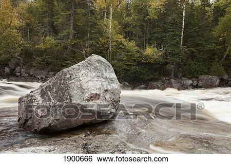 a river rushing past a boulder in autumn; ontario, canada View Large Photo Image Stock Photograph - a river rushing past a boulder in autumn; ontario, canada. Fotosearch