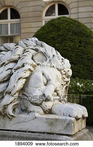 Stock Photo - a sculpture of the head of a sleeping lion; paris, france. Fotosearch