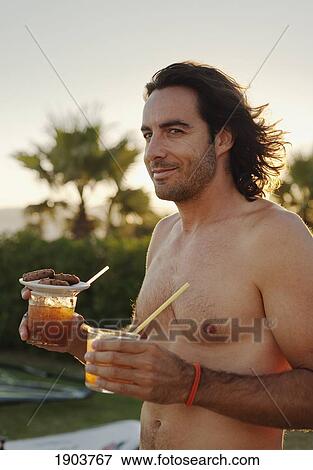 a shirtless man carries two drinks; tarifa, cadiz, andalusia, spain View Large Photo Image Stock Photo - a shirtless man carries two drinks; tarifa, cadiz, andalusia, spain. Fotosearch