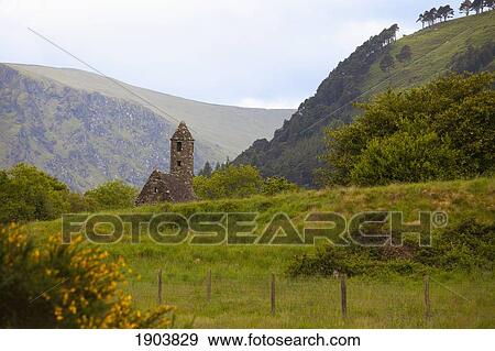 a stone building with a tower on a 6th century monastic site; county wicklow, ireland View Large Photo Image Stock Photo - a stone building with a tower on a 6th century monastic site; county wicklow, ireland. Fotosearch