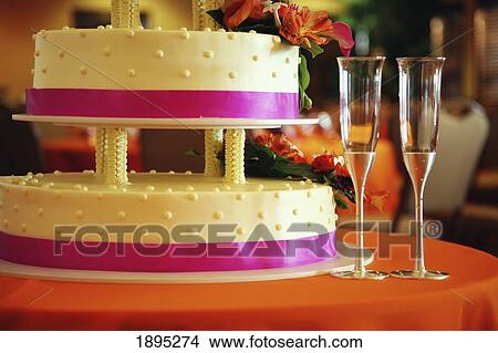 a tiered cake with two champagne glasses; gresham, oregon, united states of america View Large Photo Image Picture - a tiered cake with two champagne glasses; gresham, oregon, united states of america. Fotosearch