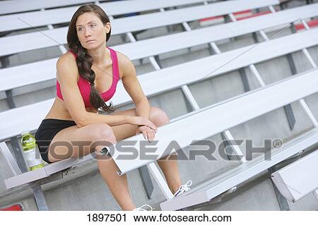 a woman dressed in exercise wear taking a rest in the stands; troutdale, oregon, united states of america View Large Photo Image Stock Image - a woman dressed in exercise wear taking a rest in the stands; troutdale, oregon, united states of america. Fotosearch