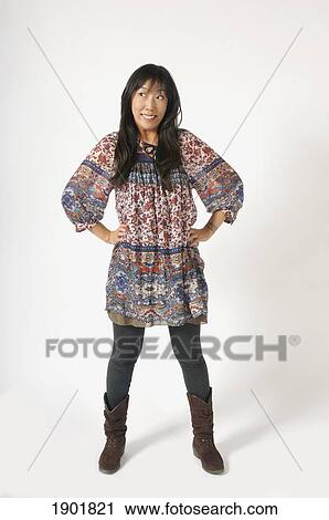 a woman standing with hands on her hips View Large Photo Image Stock Image - a woman standing with hands on her hips. Fotosearch