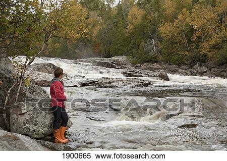 a woman stands along the riverbank; ontario, canada View Large Photo Image Stock Photography - a woman stands along the riverbank; ontario, canada. Fotosearch