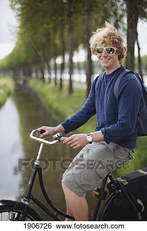 Stock Photograph - a young man on his bike; houten, the netherlands. Fotosearch