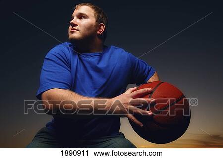 a young man playing basketball; wilmar, minnesota, united states of america View Large Photo Image Stock Image - a young man playing basketball; wilmar, minnesota, united states of america. Fotosearch