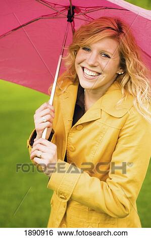 a young woman holding an umbrella; wilmar, minnesota, united states of america View Large Photo Image Stock Photograph - a young woman holding an umbrella; wilmar, minnesota, united states of america. Fotosearch