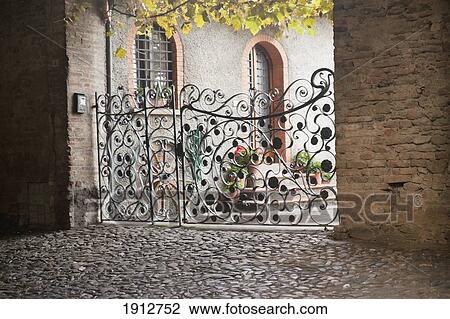 Stock Image - an intricately designed gate; italy. Fotosearch