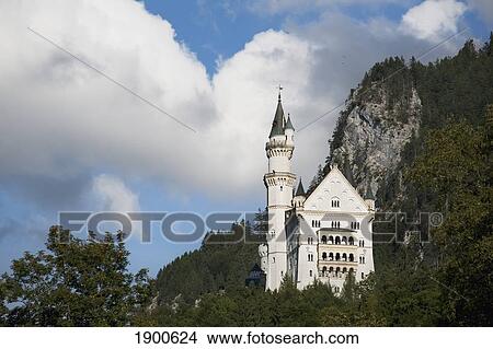 bavarian castle on a mountain side with clouds overhead; fussen, germany View Large Photo Image Picture - bavarian castle on a mountain side with clouds overhead; fussen, germany. Fotosearch