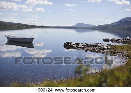 boat on a tranquil lake; vang, norway View Large Photo Image Picture - boat on a tranquil lake; vang, norway. Fotosearch