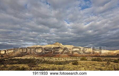 breaking storm creates a dramatic sky and spotlighting on sandstone cliffs in the chama basin; new mexico, united states of america View Large Photo Image Stock Image - breaking storm creates a dramatic sky and spotlighting on sandstone cliffs in the chama basin; new mexico, united states of america. Fotosearch