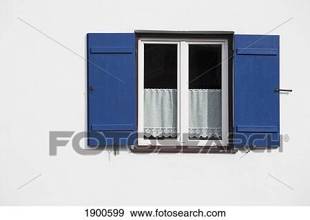 bright blue shutters on a white wall with lace curtains in the window; oberstdorf, germany View Large Photo Image Stock Photo - bright blue shutters on a white wall with lace curtains in the window; oberstdorf, germany. Fotosearch
