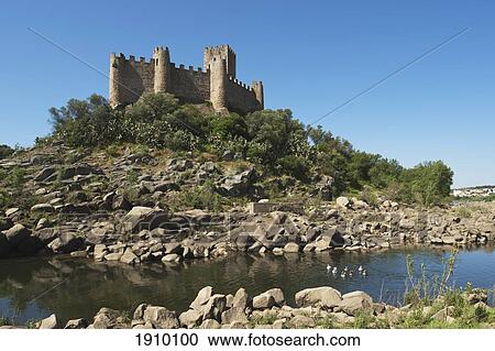 Stock Image - castelo de almourol standing in the middle of the river tejo, constructed in 1171 by the knights templar; estremadura and ribatejo, portugal. Fotosearch