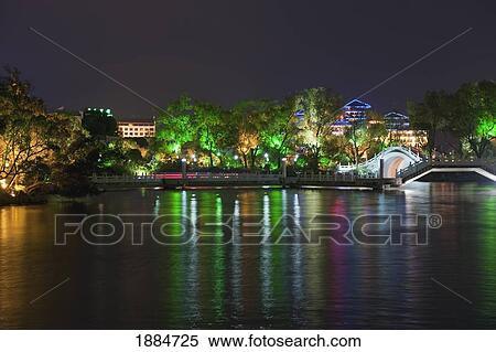 Stock Photography - city lights at night reflected on guilan's shan lake; guilan, guangxi, china. Fotosearch
