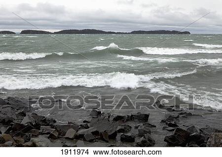 crashing waves on the rocky shoreline of lake superior; thunder bay, ontario, canada View Large Photo Image Picture - crashing waves on the rocky shoreline of lake superior; thunder bay, ontario, canada. Fotosearch