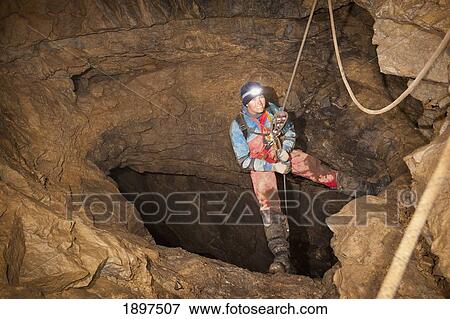 female athlete exploring a cave; fernie, british columbia, canada View Large Photo Image Stock Photo - female athlete exploring a cave; fernie, british columbia, canada. Fotosearch