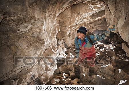 female athlete exploring a cave; fernie, british columbia, canada View Large Photo Image Stock Photograph - female athlete exploring a cave; fernie, british columbia, canada. Fotosearch
