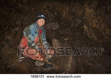 female exploring a cave; fernie, british columbia, canada View Large Photo Image Stock Image - female exploring a cave; fernie, british columbia, canada. Fotosearch