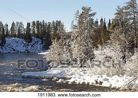 Stock Image - frost, snow and ice along a river; thunder bay, ontario, canada. Fotosearch