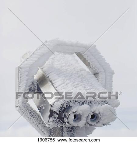 Stock Photograph - ice crystals clinging to outdoor binoculars; chamonix, france. Fotosearch