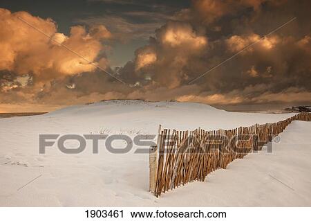 illuminated clouds glowing over a snow covered field and fence; south shields, tyne and wear, england View Large Photo Image Stock Image - illuminated clouds glowing over a snow covered field and fence; south shields, tyne and wear, england. Fotosearch