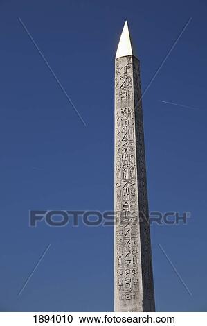 Stock Image - luxor obelisk against a blue sky; paris, france. Fotosearch
