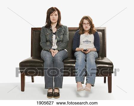 Stock Photo - mother and daughter ignoring each other; edmonton, alberta, canada. Fotosearch