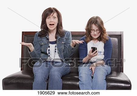 mother frustrated with preoccupied teenager; edmonton, alberta, canada View Large Photo Image Stock Photo - mother frustrated with preoccupied teenager; edmonton, alberta, canada. Fotosearch