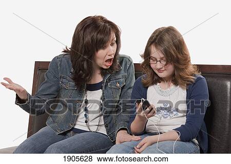 mother shocked at daughter's music selection; edmonton, alberta, canada View Large Photo Image Stock Photo - mother shocked at daughter's music selection; edmonton, alberta, canada. Fotosearch