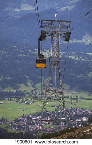 mountain gondola and tower with a village in the background; oberstdorf, germany View Large Photo Image Stock Image - mountain gondola and tower with a village in the background; oberstdorf, germany. Fotosearch