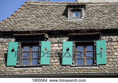 old tile roof and green shuttered windows on a medieval building; strasbourg, france View Large Photo Image Picture - old tile roof and green shuttered windows on a medieval building; strasbourg, france. Fotosearch