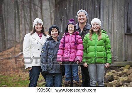 Stock Image - portrait of a family in a snowfall; grimsby, ontario, canada. Fotosearch