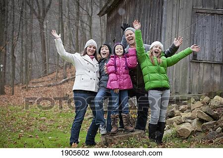 Stock Image - portrait of a family in a snowfall; grimsby, ontario, canada. Fotosearch