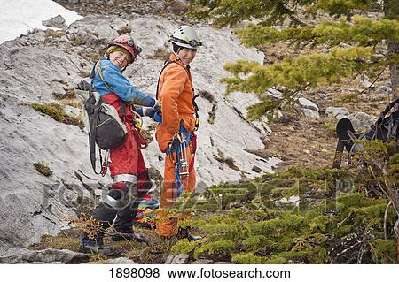 Stock Photo - preparing for a caving adventure; fernie, british columbia, canada. Fotosearch