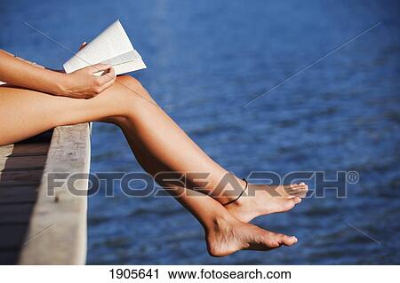 reading a book along the edge of dock; currumbin, gold coast, queensland, australia View Large Photo Image Stock Image - reading a book along the edge of dock; currumbin, gold coast, queensland, australia. Fotosearch