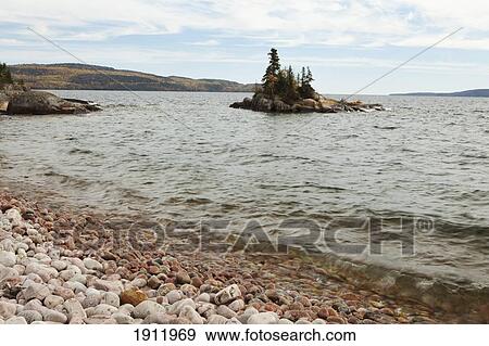 red rocks on the shore of lake superior with an island; rossport, ontario, canada View Large Photo Image Stock Photo - red rocks on the shore of lake superior with an island; rossport, ontario, canada. Fotosearch