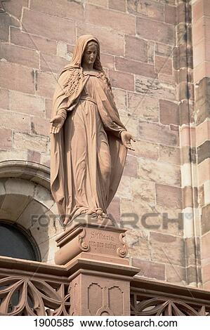 sandstone statue of mary looking down on top of a rail with stone work of a cathedral in the background; freiburg, germany View Large Photo Image Stock Photography - sandstone statue of mary looking down on top of a rail with stone work of a cathedral in the background; freiburg, germany. Fotosearch