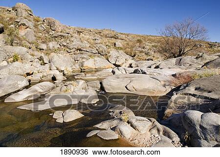 Stock Photograph - stream surrounded by a rocky, dry terrain; cordoba, argentina. Fotosearch