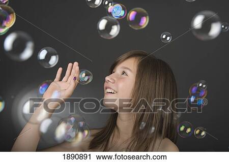 teenage girl playing with bubbles View Large Photo Image Stock Image - teenage girl playing with bubbles. Fotosearch