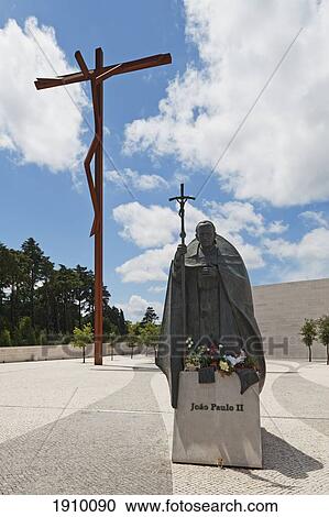 Stock Image - the high cross and a statue of pope john paul ii at the basilica of fatima; fatima, estremadura and ribatejo, portugal. Fotosearch