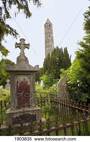 Stock Photography - tombstones in a cemetery and a round tower on a 6th century monastic site; glendalough, county wicklow, ireland. Fotosearch