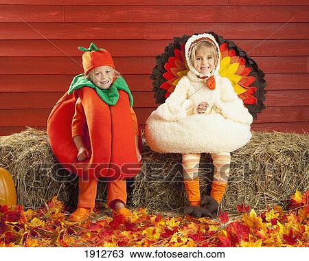 Stock Image - two children in costumes in autumn; three hills, alberta, canada. Fotosearch