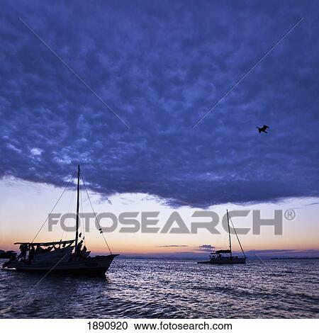 Stock Image - two fishing boats off the waters of belize; belize, central america. Fotosearch
