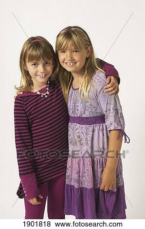 two girls wearing purple with their arms around each other View Large Photo Image Stock Photo - two girls wearing purple with their arms around each other. Fotosearch